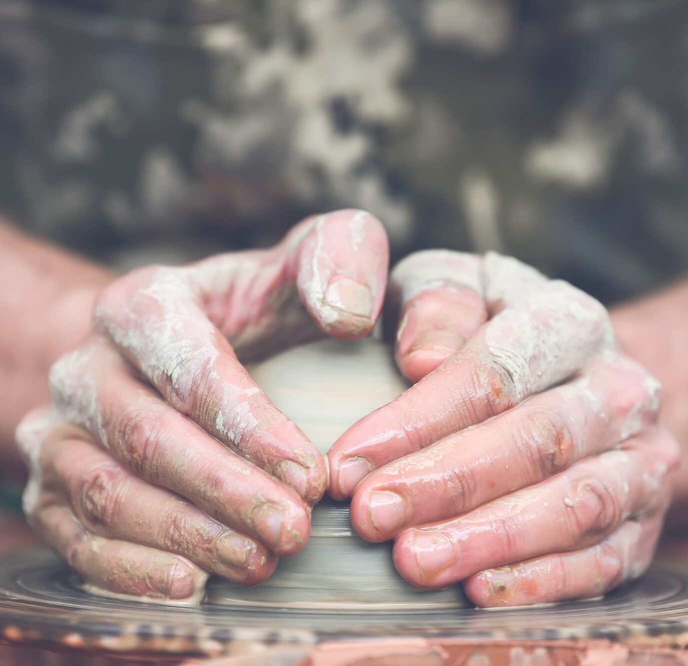 Potter making ceramic pot on the pottery wheel
